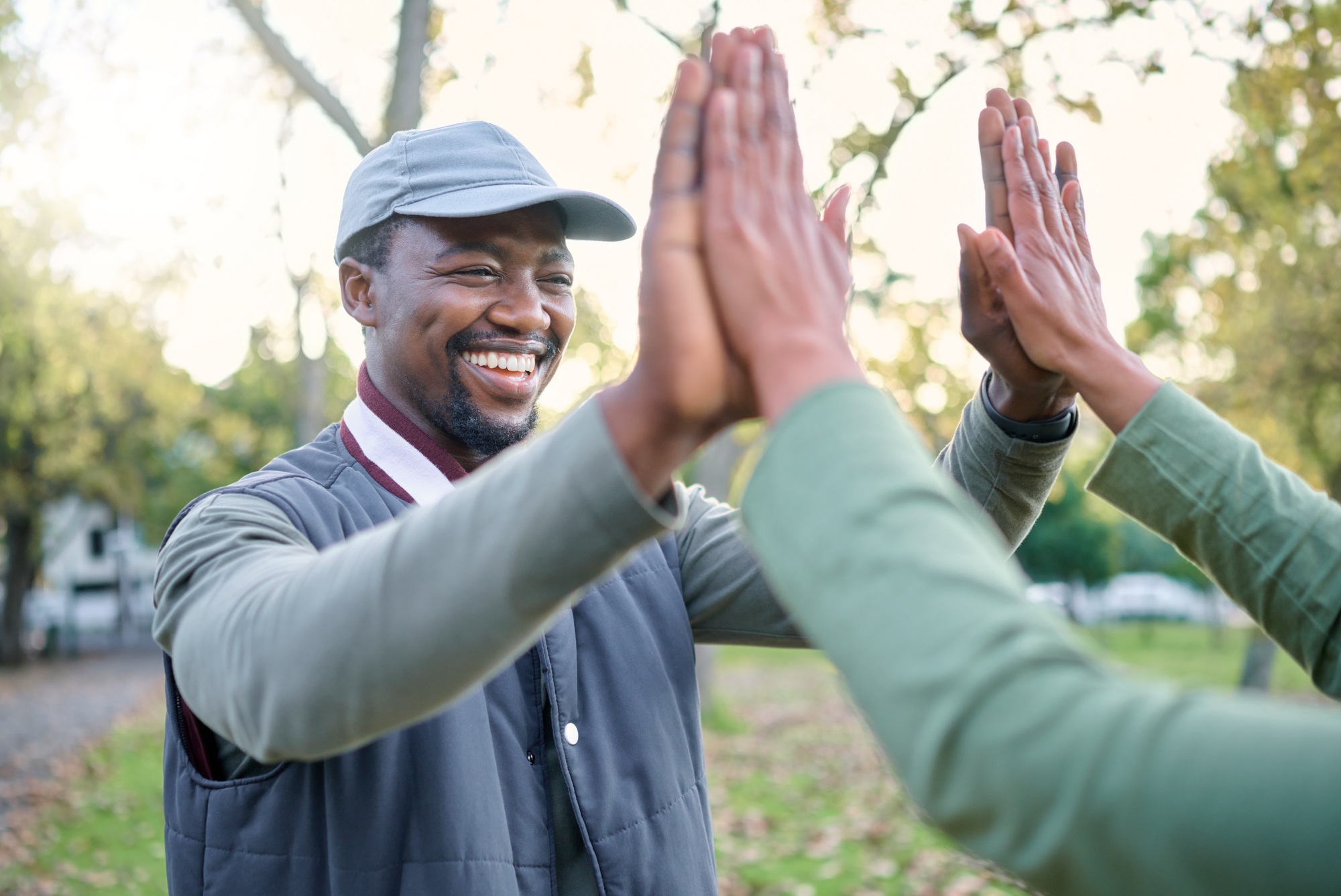 High five, nature volunteer or people celebrate cleaning garbage pollution, waste product or enviro